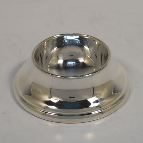 A handsome Sterling Silver tea strainer and dregs bowl, having a round hand-pierced bowl, with two hand-pierced side-handles, and sitting on an original plain round dregs stand. This elegant silver tea strainer and bowl was made by Larson Ltd. of Birmingham in 1957. The dimensions of this fine hand-made silver tea strainer and dregs stand are height 3 cms (1.25 inches), diameter of dregs stand 8 cms (3.25 inches), and it weighs a total of approx. 63g (2 troy ounces).   