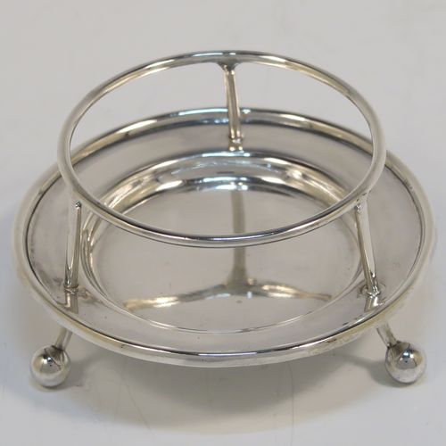 A very stylish Antique Sterling Silver tea strainer and stand, having a round hand-pierced bowl with two florally pierced side-handles, all sitting on an original plain round dregs stand with a wire-work galleried holder on a base with three ball feet. This elegant antique silver tea strainer and stand was made by George Howson of Sheffield in 1920. The dimensions of this fine hand-made antique silver tea strainer and stand are height 4 cms (1.5 inches), length over handles 10 cms (4 inches), and it weighs a total of approx. 80g (2.6 troy ounces).