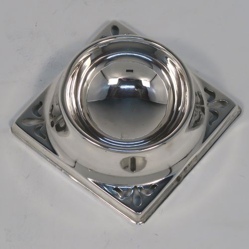 A handsome Sterling Silver tea strainer and dregs bowl, having a Georgian lemon strainer style round hand-pierced bowl, with two hand-pierced side-handles, and sitting on an original plain round dregs stand with a square base. This elegant silver tea strainer and bowl was made by Thomas Bishton of Birmingham in 1944. The dimensions of this fine hand-made silver tea strainer and dregs stand are height 2.5 cms (1 inch), length of strainer 11.5 cms (4.25 inches), and the dregs stand is 7.5 cms (3 inches) square inches), and it weighs a total of approx. 68g (2.2 troy ounces).