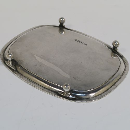 A very pretty Antique Georgian Sterling Silver teapot stand, having a rectangular body with rounded corners and a band of bright-cut hand-engraved floral decoration, a raised border with an applied reeded edge, and sitting on four ball feet. This elegant antique silver teapot stand was made by Soloman Hougham of London in 1804. The dimensions of this fine hand-made antique silver teapot stand are length 16 cms (6.3 inches), width 12.5 cms (5 inches), and it weighs approx. 153g (4.9 troy ounces).