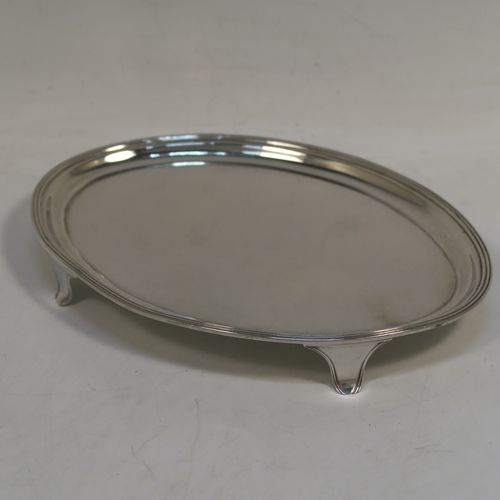 A handsome Antique Georgian Sterling Silver teapot stand having a plain oval body with applied reeded border, and all sitting on four flange feet. This beautiful antique silver teapot stand was made by Henry Chawner of London in 1795. The dimensions of this fine hand-made antique silver teapot stand are length 18 cms (7 inches), width 12.5 cms (5 inches), and it weighs approx. 147g (4.7 troy ounces).