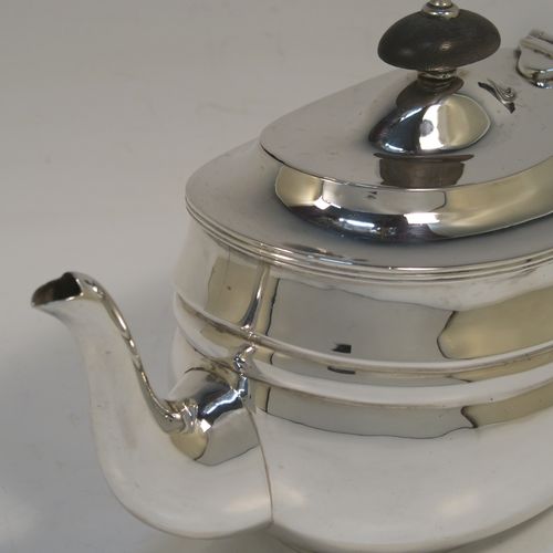A very handsome Antique Sterling Silver teapot, having a plain oval body with curved sides and reeded decoration, a curved tapering spout, a wooden scroll handle and finial, a hinged domed lid, and all sitting on a flat base. This elegant silver teapot was made by Nathan and Hayes of Chester in 1912. The dimensions of this fine hand-made antique silver teapot are length 23 cms (9 inches), height 12.5 cms (5 inches), and it weighs approx. 350g (11.3 troy ounces).