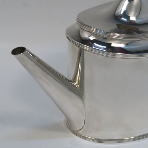 A very handsome Neoclassical style Antique Sterling Silver teapot, having a very plain oval straight-sided body with applied reeded borders, a straight tapering spout, a wooden scroll handle, a hinged domed lid with an oval wooden finial, and all sitting on a flat base. This very elegant antique silver teapot was made by Robert Stewart of Birmingham in 1922. The dimensions of this fine hand-made antique silver teapot are length 27 cms (10.5 inches), height 14 cms (5.5 inches), and it weighs approx. 450g (14.5 troy ounces).