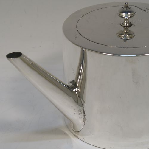 A very stylish and handsome Antique Victorian Sterling Silver teapot, having a very plain round straight-sided body, a straight tapering spout, a wooden scroll handle, an invisibly hinged flat lid with a cast round finial, and all sitting on a flat base. This beautiful antique silver teapot was made by Charles Stuart Harris of London in 1870. The dimensions of this fine hand-made antique silver teapot are length 23 cms (9 inches), height 11.5 cms (4.5 inches), diameter of main body 11 cms (4.3 inches), and it weighs approx. 450g (14.5 troy ounces).
