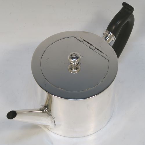A very stylish and handsome Antique Victorian Sterling Silver teapot, having a very plain round straight-sided body, a straight tapering spout, a wooden scroll handle, an invisibly hinged flat lid with a cast round finial, and all sitting on a flat base. This beautiful antique silver teapot was made by Charles Stuart Harris of London in 1870. The dimensions of this fine hand-made antique silver teapot are length 23 cms (9 inches), height 11.5 cms (4.5 inches), diameter of main body 11 cms (4.3 inches), and it weighs approx. 450g (14.5 troy ounces).