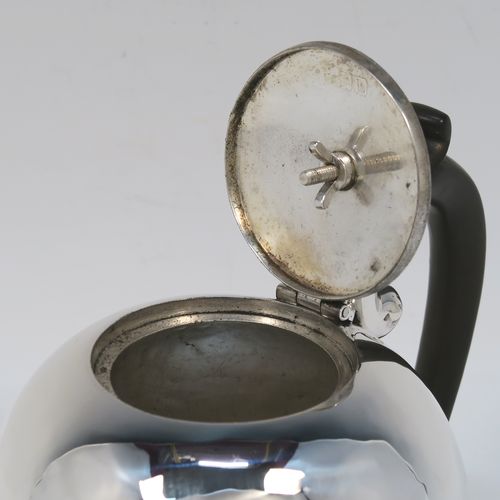 A small but beautifully made Antique Victorian Sterling Silver teapot in an early George II Bullet or Skittle Ball style, having a very plain round bellied body, a curved spout, a wooden scroll handle and finial, a hinged flat lid, and sitting flat base. This elegant silver bachelor sized teapot was made by Wakely and Wheeler of London in 1897. The dimensions of this fine hand-made silver skittle ball style teapot are length 17 cms (6.75 inches), height 11.5 cms (4.5 inches), and it weighs approx. 200g (6.5 troy ounces).