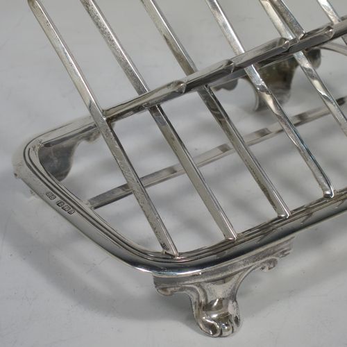 A very unusual Arts and Crafts style Antique Victorian Sterling Silver seven-bar toast-rack, in a very angular style inspired by a Christopher Dresser design, attached to a rectangular base with a reeded border and a strengthening strut, and sitting on four cast foliate and scroll feet. Made by Henry Stratford (who had links with Christopher Dresser) of Sheffield in 1893. The dimensions of this fine hand-made antique silver toast-rack are length 16 cms (6.25 inches), height 14 cms (5.5 inches), width 10 cms (4 inches), and it weighs approx. 348g (11.2 troy ounces).