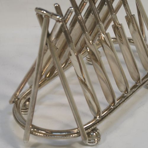 A very unusual Antique Victorian Silver-Plated seven-bar toast-rack, having crossed cricket bats with wickets and bails, and sitting on a rounded rectangular base with four cricket ball feet, and a round loop handle. This beautiful and rare Cricket designed toastrack was made by Padley, Parkin and Co., of Sheffield in ca. 1880. The dimensions of this fine hand-made antique silver plated cricket toast-rack are length 18 cms (7 inches), height 16 cms (6.3 inches), and width 8 cms (3.25 inches).