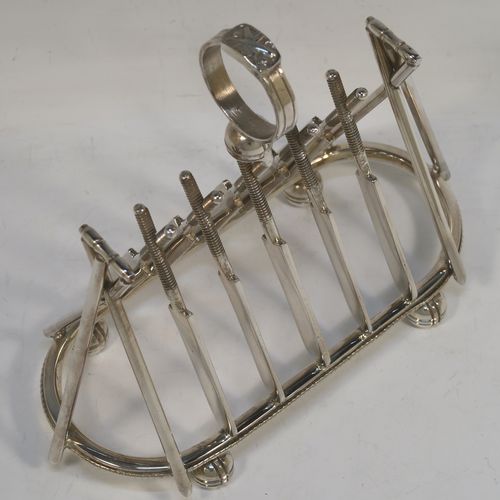 A very unusual Antique Victorian Silver-Plated seven-bar toast-rack, having crossed cricket bats with wickets and bails, and sitting on a rounded rectangular base with four cricket ball feet, and a round loop handle. This beautiful and rare Cricket designed toastrack was made by Padley, Parkin and Co., of Sheffield in ca. 1880. The dimensions of this fine hand-made antique silver plated cricket toast-rack are length 18 cms (7 inches), height 16 cms (6.3 inches), and width 8 cms (3.25 inches).