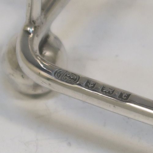 A very elegant Antique Sterling Silver seven-bar toastrack, having plain shaped cross-section wire-work bars, a matching loop handle, and all sitting on a rectangular base with four cast ball feet. This handsome antique silver toast-rack was made by Alexander Clark and Co. Ltd., of Birmingham in 1918. The dimensions of this fine hand-made antique silver toast-rack are length 13 cms (5 inches), height 12 cms (4.75 inches), width 8 cms (3.25 inches), and it weighs approx. 160g (5.2 troy ounces).