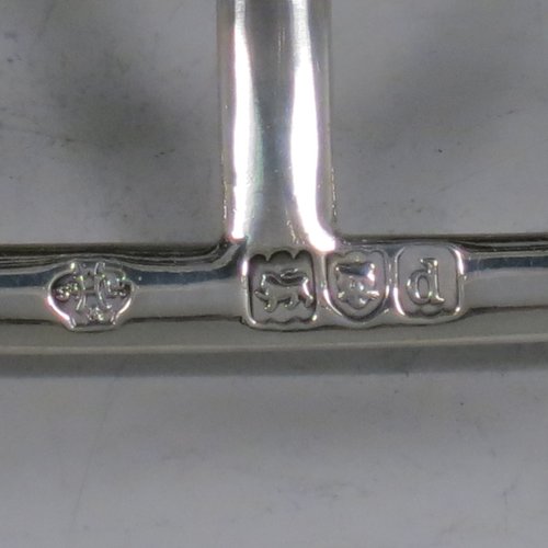 An Antique Victorian Sterling Silver large pair of seven-bar toast-racks, having shaped wire-work bars, matching loop handles, and sitting on rectangular bases with four ball feet. Made William Hutton of London in 1899/1900. The dimensions of this fine hand-made pair of silver toastracks are length 16 cms (6.25 inches), height 15 cms (6 inches), width 11 cms (4.25 inches), and they weigh approx. 612g (19.7 troy ounces).