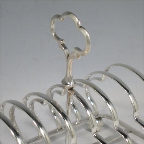 An Antique Victorian Sterling Silver large pair of seven-bar toast-racks, having shaped wire-work bars, matching loop handles, and sitting on rectangular bases with four ball feet. Made William Hutton of London in 1899/1900. The dimensions of this fine hand-made pair of silver toastracks are length 16 cms (6.25 inches), height 15 cms (6 inches), width 11 cms (4.25 inches), and they weigh approx. 612g (19.7 troy ounces).