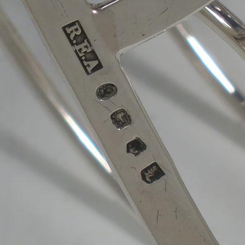 A very handsome Antique Georgian Sterling Silver seven-bar toast-rack, having oval shaped wire-work bars, a loop handle, attached to a rectangular base with a strengthening strut, and sitting on four ball feet. Made by Robinson, Edkins, and Aston of London in 1834. The dimensions of this fine hand-made antique silver toast-rack are length 15 cms (6 inches), height 12 cms (4.75 inches), width 11.5 cms (4.5 inches), and it weighs approx. 242g (7.8 troy ounces).