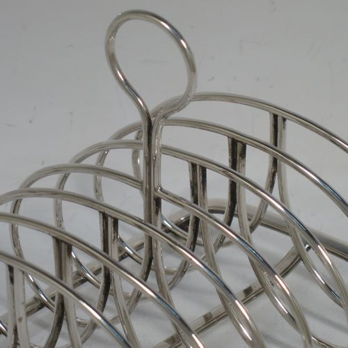 A very handsome Antique Georgian Sterling Silver seven-bar toast-rack, having oval shaped wire-work bars, a loop handle, attached to a rectangular base with a strengthening strut, and sitting on four ball feet. Made by Robinson, Edkins, and Aston of London in 1834. The dimensions of this fine hand-made antique silver toast-rack are length 15 cms (6 inches), height 12 cms (4.75 inches), width 11.5 cms (4.5 inches), and it weighs approx. 242g (7.8 troy ounces).