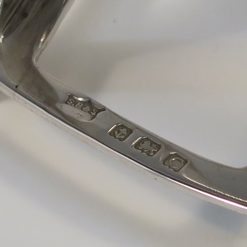 A handsome Art Deco Sterling Silver seven-bar toast-rack, in a very angular arch style design, with a carrying handle, all attached to a rectangular base with strengthening strut, and sitting on four flanged feet. This handsome silver toastrack was made by S. Blanckensee and Sons of Birmingham in 1927. The dimensions of this fine hand-made Art Deco silver toast-rack are length 16.5 cms (6.5 inches), height 12 cms (4.75 inches), width 8 cms (3 inches), and it weighs approx. 168g (5.4 troy ounces).