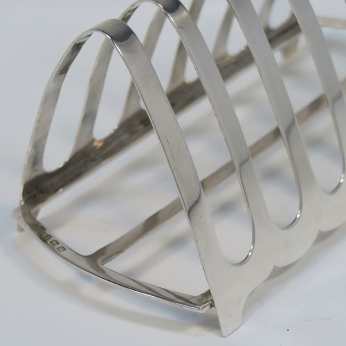 A handsome Art Deco Sterling Silver seven-bar toast-rack, in a very angular arch style design, with a carrying handle, all attached to a rectangular base with strengthening strut, and sitting on four flanged feet. This handsome silver toastrack was made by S. Blanckensee and Sons of Birmingham in 1927. The dimensions of this fine hand-made Art Deco silver toast-rack are length 16.5 cms (6.5 inches), height 12 cms (4.75 inches), width 8 cms (3 inches), and it weighs approx. 168g (5.4 troy ounces).
