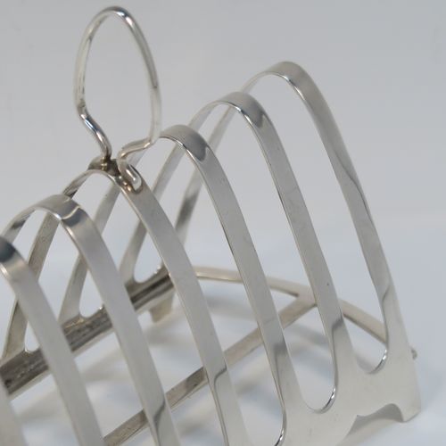 A handsome Art Deco Sterling Silver seven-bar toast-rack, in a very angular arch style design, with a carrying handle, all attached to a rectangular base with strengthening strut, and sitting on four flanged feet. This handsome silver toastrack was made by S. Blanckensee and Sons of Birmingham in 1927. The dimensions of this fine hand-made Art Deco silver toast-rack are length 16.5 cms (6.5 inches), height 12 cms (4.75 inches), width 8 cms (3 inches), and it weighs approx. 168g (5.4 troy ounces).