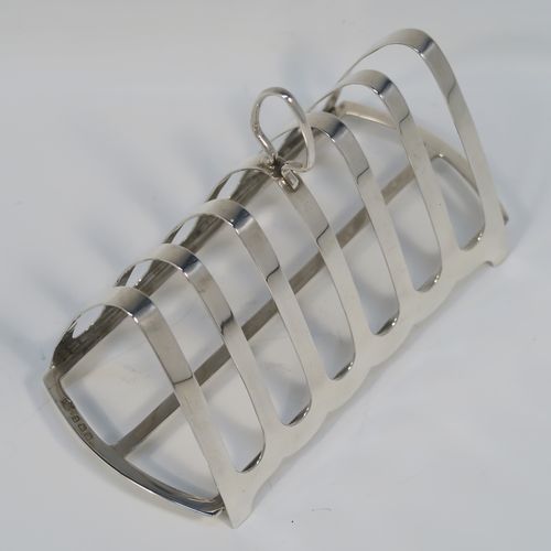 A handsome Art Deco Sterling Silver seven-bar toast-rack, in a very angular arch style design, with a carrying handle, all attached to a rectangular base with strengthening strut, and sitting on four flanged feet. This handsome silver toastrack was made by S. Blanckensee and Sons of Birmingham in 1927. The dimensions of this fine hand-made Art Deco silver toast-rack are length 16.5 cms (6.5 inches), height 12 cms (4.75 inches), width 8 cms (3 inches), and it weighs approx. 168g (5.4 troy ounces).