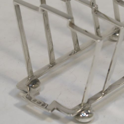 A very stylish Art Deco Sterling Silver five-bar toast-rack, in a very angular style design, attached to a rectangular base and sitting on four round cushion feet. this elegant silver toastrack was made by Alexander Clark and Co., of Birmingham in 1932. The dimensions of this fine hand-made Art Deco silver toast-rack are length 13.5 cms (5.25 inches), height 10 cms (4 inches), width 7 cms (2.75 inches), and it weighs approx. 127g (4 troy ounces).
