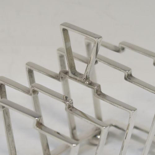 A very stylish Art Deco Sterling Silver five-bar toast-rack, in a very angular style design, attached to a rectangular base and sitting on four round cushion feet. this elegant silver toastrack was made by Alexander Clark and Co., of Birmingham in 1932. The dimensions of this fine hand-made Art Deco silver toast-rack are length 13.5 cms (5.25 inches), height 10 cms (4 inches), width 7 cms (2.75 inches), and it weighs approx. 127g (4 troy ounces).