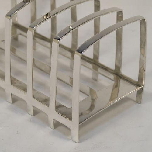 An elegant Antique Art Deco Sterling Silver seven-bar toast-rack, in a very angular style design, with a square-shaped handle, all attached to a rectangular base with strengthening strut, and sitting on multiple legs. This handsome silver toastrack was made by James Dixon and Sons of Sheffield in 1922. The dimensions of this fine hand-made Art Deco antique silver toast-rack are length 13.5 cms (5.25 inches), height 13.5 cms (5.25 inches), width 7 cms (2.75 inches), and it weighs approx. 212g (6.8 troy ounces).