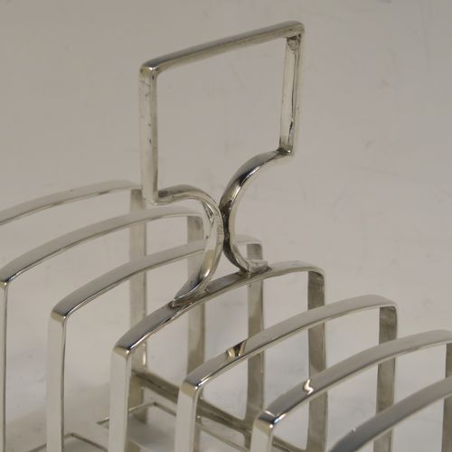 An elegant Antique Art Deco Sterling Silver seven-bar toast-rack, in a very angular style design, with a square-shaped handle, all attached to a rectangular base with strengthening strut, and sitting on multiple legs. This handsome silver toastrack was made by James Dixon and Sons of Sheffield in 1922. The dimensions of this fine hand-made Art Deco antique silver toast-rack are length 13.5 cms (5.25 inches), height 13.5 cms (5.25 inches), width 7 cms (2.75 inches), and it weighs approx. 212g (6.8 troy ounces).