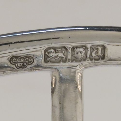 A handsome Antique Sterling Silver seven-bar toastrack, having plain rounded wire-work bars, a matching loop handle, all sitting on a rectangular base with a strengthening strut, on four cast cushion feet. This elegant antique silver toast-rack was made by Goldsmiths and Silversmiths of London in 1916. The dimensions of this fine hand-made antique silver toast-rack are length 16 cms (6.3 inches), height 11.5 cms (4.5 inches), width 8 cms (3 inches), and it weighs approx. 265g (8.5 troy ounces).