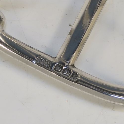 A very handsome Antique Victorian Sterling Silver seven-bar toastrack, having plain arched cross-section wire-work bars, an unusual loop handle, all sitting on a rectangular base with a strengthening strut, on four cast cushion feet. This elegant antique silver toast-rack was made by Walker and Hall of Sheffield in 1894. The dimensions of this fine hand-made antique silver toast-rack are length 12 cms (4.75 inches), height 12 cms (4.75 inches), width 7 cms (2.75 inches), and it weighs approx. 196g (6.3 troy ounces).