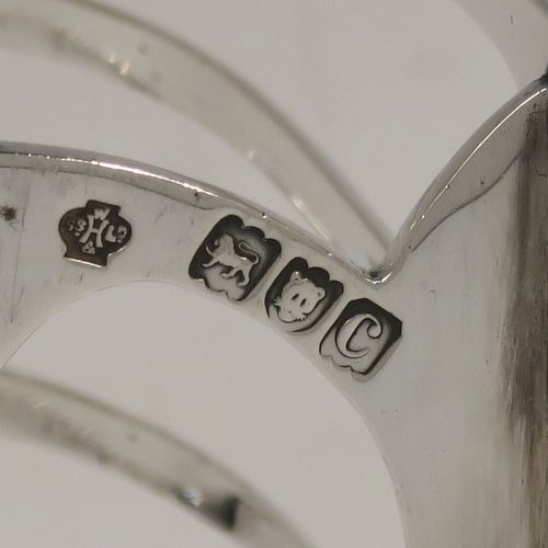 A handsome and heavy Antique Victorian Sterling Silver seven-bar toastrack, having plain rounded wire-work bars, a matching loop handle, all sitting on a rectangular base with a strengthening strut. This elegant antique silver toast-rack was made by William Hutton of London in 1898. The dimensions of this fine hand-made antique silver toast-rack are length 15 cms (6 inches), height 15 cms (6 inches), width 8 cms (3 inches), and it weighs approx. 305g (9.8 troy ounces).