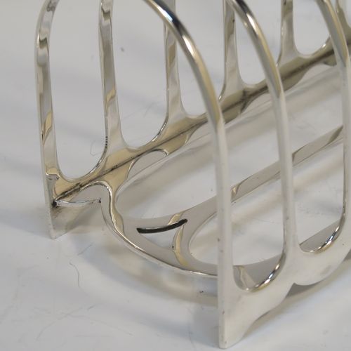 A handsome and heavy Antique Victorian Sterling Silver seven-bar toastrack, having plain rounded wire-work bars, a matching loop handle, all sitting on a rectangular base with a strengthening strut. This elegant antique silver toast-rack was made by William Hutton of London in 1898. The dimensions of this fine hand-made antique silver toast-rack are length 15 cms (6 inches), height 15 cms (6 inches), width 8 cms (3 inches), and it weighs approx. 305g (9.8 troy ounces).