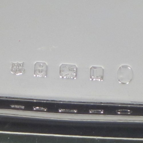 Sterling silver sandwich tray, having a rectangular body with rounded corners, a very plain ground, a raised border with an applied gadroon edge, and sitting on a flat base. Made by the Barker Brothers of Birmingham in 1921. The dimensions of this fine hand-made silver sandwich tray are length 39.5 cms (15.5 inches), width 17 cms (6.75 inches), and it weighs approx. 640g (20.6 troy ounces).