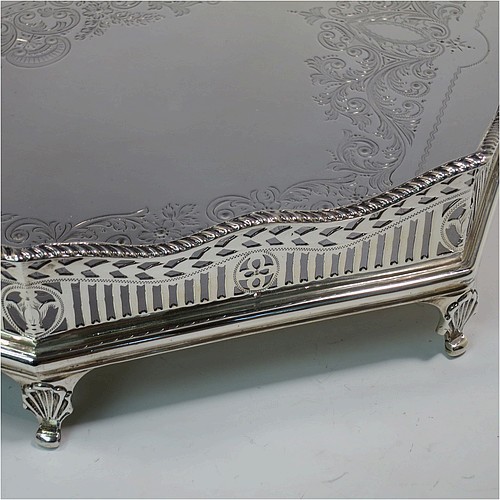 A very pretty Antique Victorian Sterling Silver gallery tray, having an elongated octagonal body, a hand-engraved ground with floral and scroll decoration, hand-pierced gallery sides with applied gadroon borders and oval cut-out handles, and sitting on eight cast shell flange feet. This beautiful silver tray was made by Charles Clement Pilling of Sheffield in 1901. The dimensions of this fine hand-made antique silver tray are length 57 cms (22.5 inches), width 41 cms (16 inches), height 8 cms (3 inches), and it weighs approx. 3,720g (120 troy ounces).
