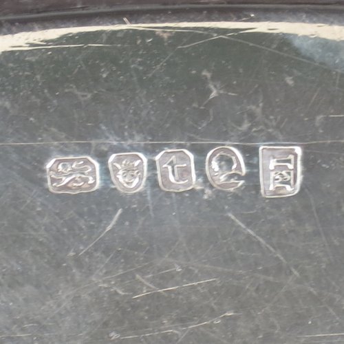 An Antique Georgian Sterling silver oval two-handled tea tray, with a beautifully hand-engraved band of floral decoration, an applied reeded border with matching cast handles, and sitting on a flat base. This handsome Georgian sterling silver tray was made by Elizabeth Jones of London in 1794. The dimensions of this fine hand-made silver tray are length inc. handles 52 cms (20.5 inches), width 34 cms (13.5 inches), and it weighs approx. 1,593g (51 troy ounces).