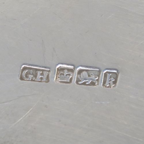 A very elegant Antique Edwardian Sterling Silver tray, having a shaped oval body with a plain ground, an applied shell and scroll border, and two cast side-handles, all sitting on a flat base. This classical silver tray was made by George Howson of Sheffield in 1902. The dimensions of this fine hand-made antique silver tray are length (inc. handles) 74 cms (29 inches), width 48 cms (19 inches), and it weighs approx. 3,510g (117 troy ounces).