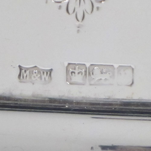 Antique Edwardian sterling silver tea tray, having a rectangular body, with applied cast gadroon and shell border, two cast handles, and a hand-engraved ground with floral decoration, all sitting on a flat base. Made by Mappin and Webb of Sheffield in 1905. The dimensions of this fine hand-made silver tea tray are length (inc. handles) 70 cms (27.5 inches), width 41 cms (16 inches), and it weighs approx. 3,410g (110 troy ounces).