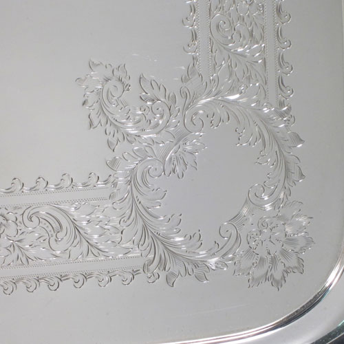 Antique Edwardian sterling silver tea tray, having a rectangular body, with applied cast gadroon and shell border, two cast handles, and a hand-engraved ground with floral decoration, all sitting on a flat base. Made by Mappin and Webb of Sheffield in 1905. The dimensions of this fine hand-made silver tea tray are length (inc. handles) 70 cms (27.5 inches), width 41 cms (16 inches), and it weighs approx. 3,410g (110 troy ounces).