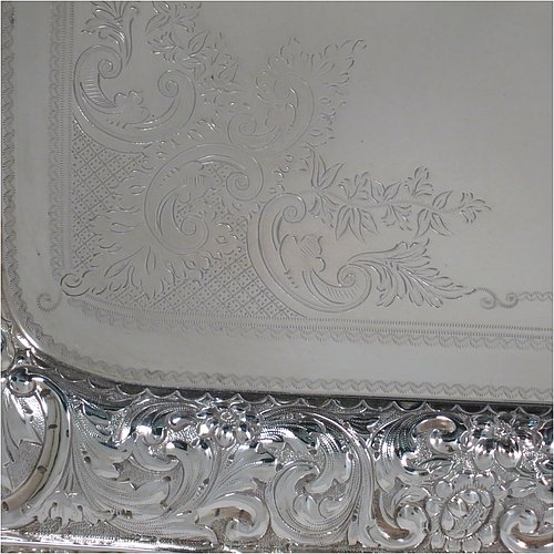 A very pretty Antique Victorian Silver Plated tray, having a rectangular body, a beautiful hand-engraved ground with floral decoration surrounding a central vacant cartouche, a hand-chased border with floral and scroll decoration, with two cast gadroon side-handles, and sitting on a flat base. This beautiful silver-plated tray was made by the Mappin Brothers of Sheffield in their top-quality Queens Plate. The dimensions of this fine hand-made silver plated tea tray are length (inc. handles) 58 cms (22.75 inches), width 38 cms (15 inches).