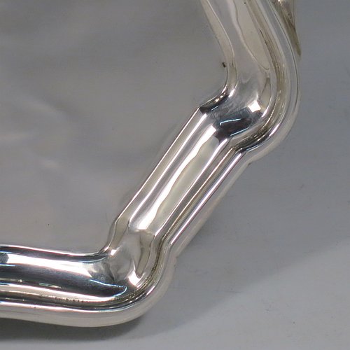A Sterling Silver tray, having a very plain ground, with an applied Bath edged border, with two cast side-handles, and sitting on a flat base. Made by Bert Gordon of Birmingham in 1949. The dimensions of this fine hand-made silver tray are length (inc. handles) 40 cms (15.75 inches), width 22 cms (8.5 inches), and it weighs approx. 884g (28.5 troy ounces).