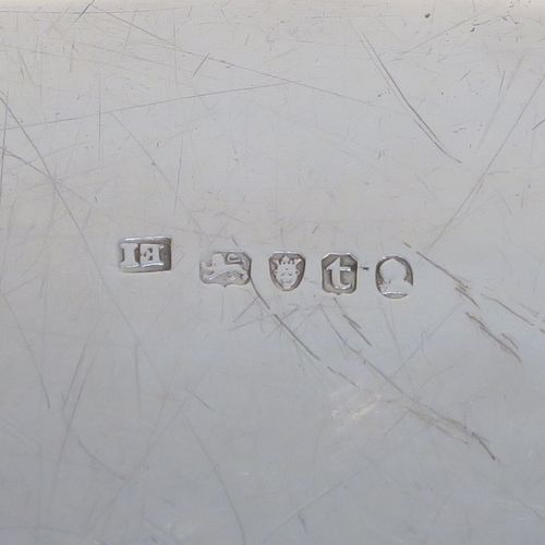 A very elegant Antique Georgian Sterling Silver oval two-handled tea tray, having a plain ground with a hand-engraved full armorial crest, an applied Reeded border, two cast reeded side handles, and all sitting on a flat base. This very handsome antique silver tray was made by Elizabeth Jones of London in 1794. The dimensions of this fine hand-made antique silver tray are length (inc. handles) 56 cms (22 inches), width 36 cms (14.25 inches), and it weighs approx. 1,923g (62 troy ounces).