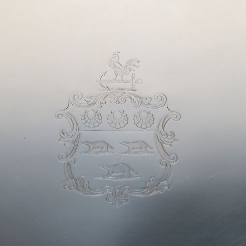 A very elegant Antique Georgian Sterling Silver oval two-handled tea tray, having a plain ground with a hand-engraved full armorial crest, an applied Reeded border, two cast reeded side handles, and all sitting on a flat base. This very handsome antique silver tray was made by Elizabeth Jones of London in 1794. The dimensions of this fine hand-made antique silver tray are length (inc. handles) 56 cms (22 inches), width 36 cms (14.25 inches), and it weighs approx. 1,923g (62 troy ounces).