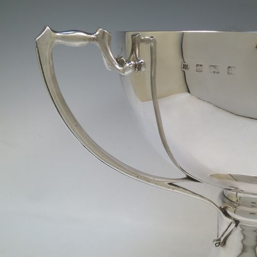 A very large and heavy Antique Edwardian Sterling Silver Art Nouveau three-handled trophy cup, having a plain round body, with three side-handles, and sitting on a plain pedestal foot. Made by Alexander Clarke & Co., of Birmingham in 1907. The dimensions of this fine hand-made large antique silver trophy cup are height 31 cms (12.25 inches), diameter of main body 27 cms (10.5 inches), and it weighs approx. 2,485g (80 troy ounces).