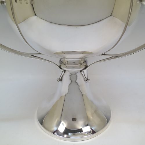 A very large and heavy Antique Edwardian Sterling Silver Art Nouveau three-handled trophy cup, having a plain round body, with three side-handles, and sitting on a plain pedestal foot. Made by Alexander Clarke & Co., of Birmingham in 1907. The dimensions of this fine hand-made large antique silver trophy cup are height 31 cms (12.25 inches), diameter of main body 27 cms (10.5 inches), and it weighs approx. 2,485g (80 troy ounces).