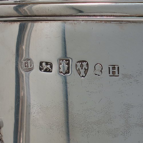 A rare Antique Georgian Sterling Silver large trophy cup and cover, having a neoclassical round plain tapering body with applied laurel-leaf cartouches, with applied reeded borders, two loop side-handles with anthemion leaf shoulders, an original cover with cast finial, and sitting on a round pedestal foot. Made by John Langland II of Newcastle in 1798. The dimensions of this fine hand-made antique silver trophy cup and cover are height 51 cms (20 inches), spread across arms 33 cms (13 inches), and it weighs approx. 3,176g (102 troy ounces). Please note that this trophy is engraved with contemporary presentation inscriptions on both sides.