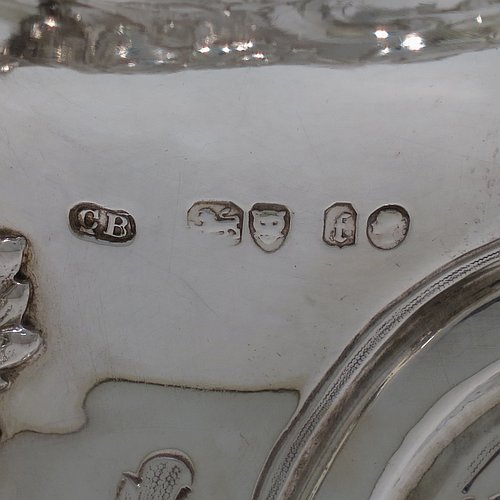 An impressive Antique Victorian Sterling Silver trophy cup, in a Campana style, having a bellied body with cartouches on both sides, with hand-chased floral and scroll decoration, with two floral scroll handles, and sitting on a pedestal foot. This beautiful antique silver trophy cup was made by Charles Boyton of London in 1861. The dimensions of this fine hand-made antique silver trophy cup are height 26 cms (10.25 inches), spread across handles 30 cms (11.75 inches), and it weighs approx. 1,291g (42 troy ounces). Please note that this item is crested on one side.