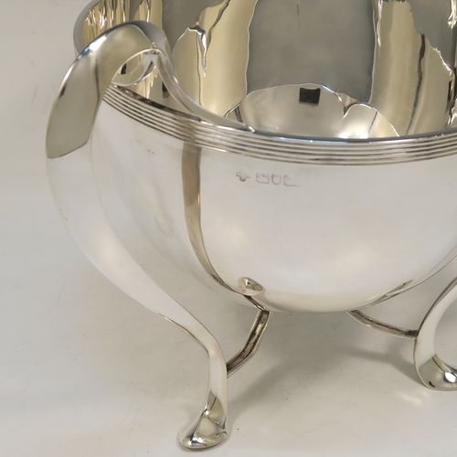 An elegant and heavy Antique Edwardian Sterling Silver three-handled Loving cup bowl, having a plain round body with tapering sides and an applied reeded top border, with three scroll side-handled feet. This handsome antique silver loving cup trophy bowl was made by Horace Woodward of London in 1903. The dimensions of this fine hand-made sterling silver trophy cup bowl are height 21 cms (8.25 inches), diameter of main body 20 cms (8 inches), and it weighs approx. 1,198g (38.6 troy ounces).  