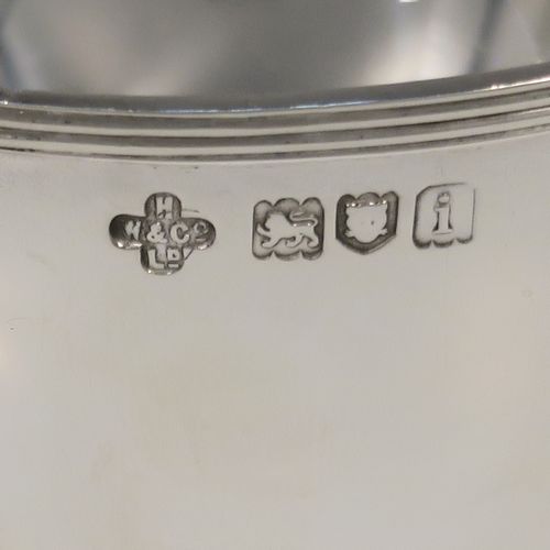 A small but very elegant and heavy Antique Edwardian Sterling Silver three-handled Loving cup bowl, having a plain round body with tapering sides and an applied reeded top border, sitting on three scroll side-handled feet. This handsome antique silver loving cup trophy bowl was made by Horace Woodward of London in 1904. The dimensions of this fine hand-made sterling silver trophy cup bowl are height 11 cms (4.25 inches), diameter of main body 10 cms (4 inches), and it weighs approx. 242g (7.8 troy ounces).