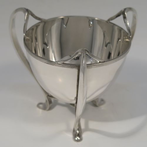 A small but very elegant and heavy Antique Edwardian Sterling Silver three-handled Loving cup bowl, having a plain round body with tapering sides and an applied reeded top border, sitting on three scroll side-handled feet. This handsome antique silver loving cup trophy bowl was made by Horace Woodward of London in 1904. The dimensions of this fine hand-made sterling silver trophy cup bowl are height 11 cms (4.25 inches), diameter of main body 10 cms (4 inches), and it weighs approx. 242g (7.8 troy ounces).