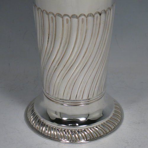 An Antique Victorian Sterling silver pair of table flower vases, having round bodies with tapering sides, hand-chased half-fluted decoration, and sitting on pedestal feet. Made by Henry Stratford of London in 1889. The dimensions of these fine hand-made antique silver pair of vases are height 19 cms (7.5 inches), diameter at top 8.5 cms (3.3 inches), and they weigh a total of approx. 487g (15.7 troy ounces). Please note that these vases are not loaded.   