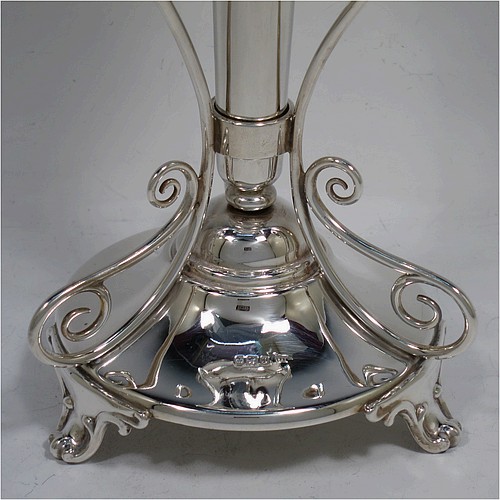A very pretty and unusual pair of Antique Edwardian Sterling Silver Art Nouveau style vases, having removable central bodies, sitting in a frame with wire-work scrolls, attached to round bases with three scroll feet. Made by Walker and Hall of Sheffield in 1907. The dimensions of this fine pair of hand-made antique silver Art Nouveau vases are height 24 cms (9.5 inches), and diameter at bases 11 cms (4.3 inches). Please note that these vases are not loaded, and the total weight of silver is 640g (20.6 troy ounces)..