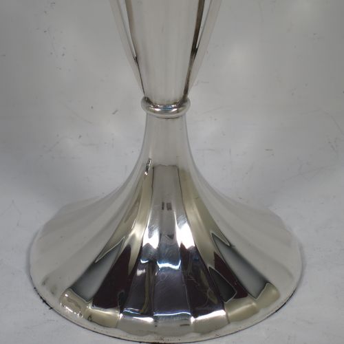 A very unusual and pretty pair of Art Deco Sterling Silver table flower vases, having tall panelled bodies with square cross-section side handles, and sitting on pedestal feet. Made by William Henry Sparrow of Birmingham in 1938. The dimensions of these fine hand-made pair of Art Deco silver vases are height 30 cms (11.75 inches), and diameter at base 8 cms (3.25 inches).